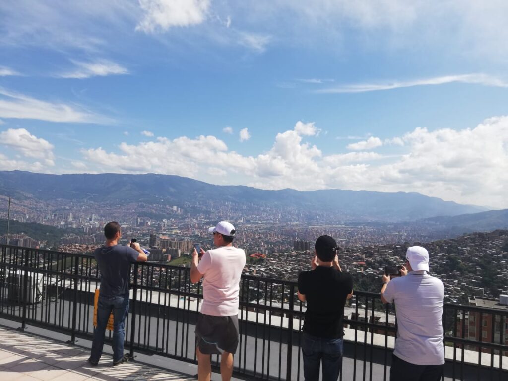 Group at a view point taking pictures of the city in a private tour Medellin